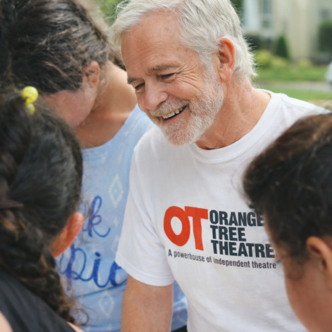 Man wearing an Orange Tree tshirt smiling